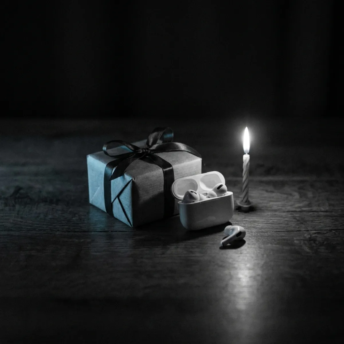 A wrapped present beside a phone playing a song